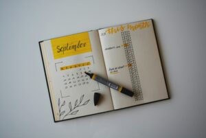 A bullet journal or planner open to September with a yellow highlighter overtop