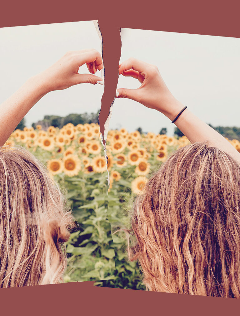 two young blonde friends facing a field of sunflowers making a heart with their hands, torn in half