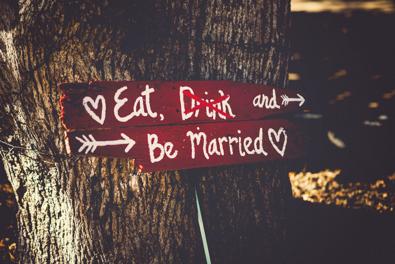 dry wedding sign reading "Eat, Drink, and be Married" with "drink" crossed out