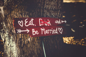 dry wedding sign reading "Eat, Drink, and be Married" with "drink" crossed out